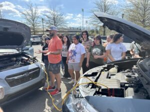 Aaron Barnett discusses car care with students.