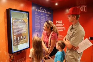 The Armstrong family looks at an exhibit.
