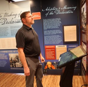 Glen Foster, a Tusculum professor, looks at an exhibit.