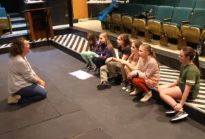 Erin Hensley Schultz, left, rehearses with children in the cast.