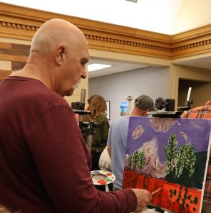 Jim Dyer applies the finishing touches to his and his wife Lisa’s painting.