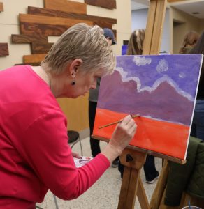 This woman works on her painting.