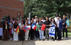 Tusculum University international students stand by the peace pole.