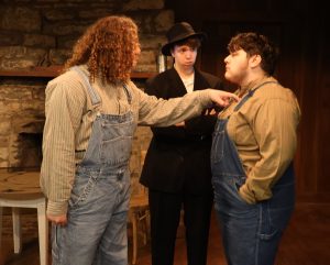Actors perform a scene during a 2025 performance of “Edgar Allan Poe and Other Haunted Stories in the Woods.”