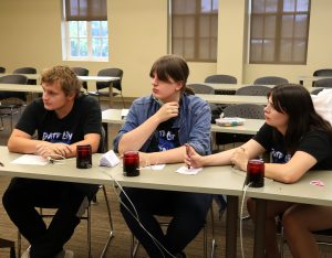Matthew Lane, left, and two of his classmates from Gate City High School participate in the Tusculum Earlybird.