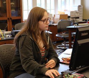 Lindi Blaylock checks statistics for the Tusculum Earlybird.