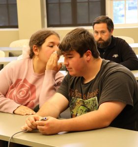 Two players confer on an answer during a game at the Tusculum Earlybird.