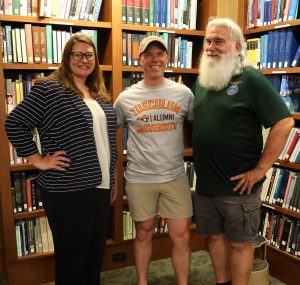 Ben Hankin, center, gathers for a photo in the Thomas J. Garland Library at Tusculum University. Joining him are Tiffany Greer, left, vice president of institutional advancement, and Bob Rediske, an alumnus of the USS Greeneville.