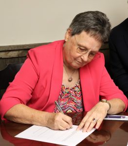 Lt. Col. Ginger Jacocks signs the document for the scholarship fund.