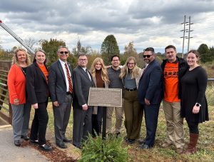 Tusculum University representatives stand with Pilloni family members by the plaque for the late Bill and Jane Pilloni.