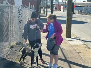Janelle Zirger, left, and Isabelle Delbridge, walk a dog as part of their service work at Cincinnati Animal Care.