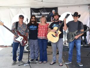 Gail Winterbauer, center, stands with the band Salty Moondogs