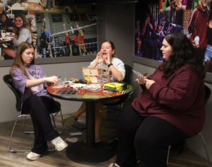 Evie Winfrey, middle, the Student Government Association’s president, calls out numbers and letters during bingo. With her are student AnnaLee Simpson, left, and Katie Odoms, Tusculum’s coordinator of housing and student records.