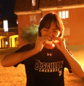 Student Penelope Lee enjoys a s’more during the Homecoming Kickoff Bonfire.