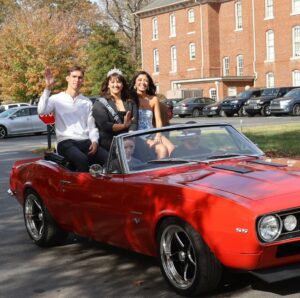 Left to right, David Evans, Jessica Silvers and Maria Torres ride in the Homecoming parade. Evans was selected as king, and Silvers was the reigning queen. Angela Sanchez was chosen as this year’s queen.