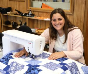 Sammy Jimenez sits with her quilt.