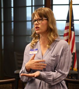 Sara McMurray speaks with a fellow attendee during a break.
