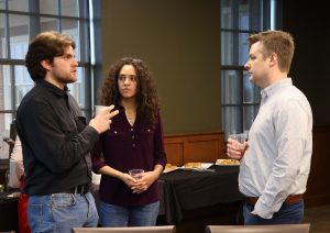 Kol Dorney, left, who runs KoldOps, networks with others at the summit.