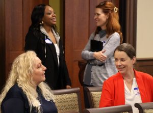 Attendees converse during a break in the summit.