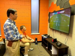 Dr. Harold Branstrator, left, and Joseph Cole play Madden 2023.