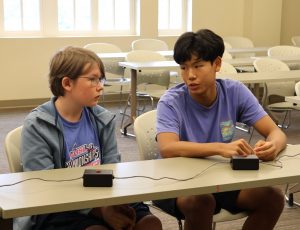 Two players consult each other on an answer.