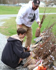 Tusculum student Isabella Gall, left, and faculty member Jordan Baker work on the trees.