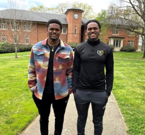 Andrae Robinson, left, and Adrian Robinson stand in front of the Thomas J. Garland Library.
