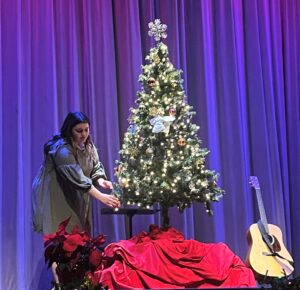 Tusculum alumna Lexie Vesser places an ornament on the tree during the vespers service in 2022.